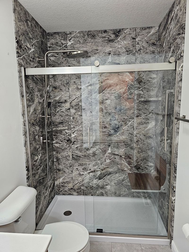 Walk-in shower with dramatic gray granite-look walls