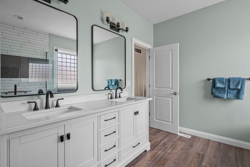 White double vanity with black mirrors