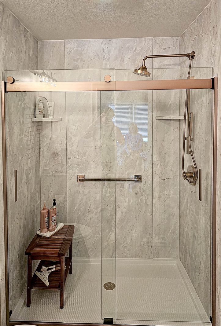 Champagne Bronze shower style with bronze-finish fixtures and door frame