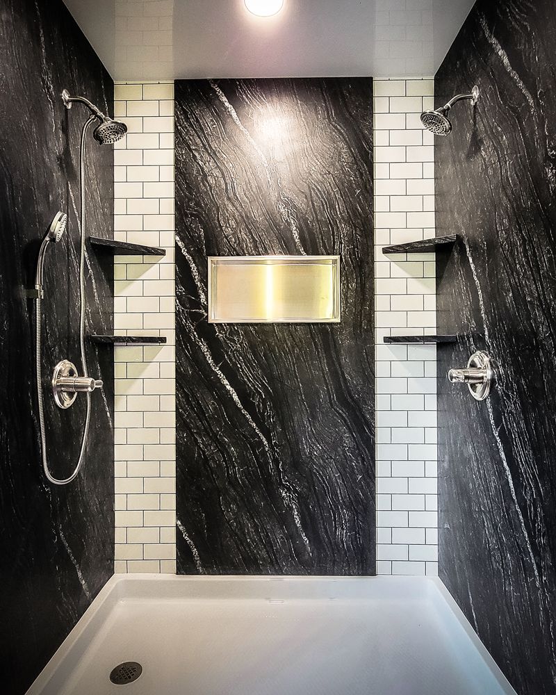 Custom shower style with black marble-look walls and white tile-look panel