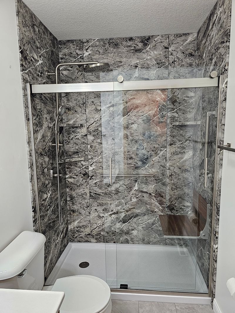 Granite shower style with gray granite-look walls