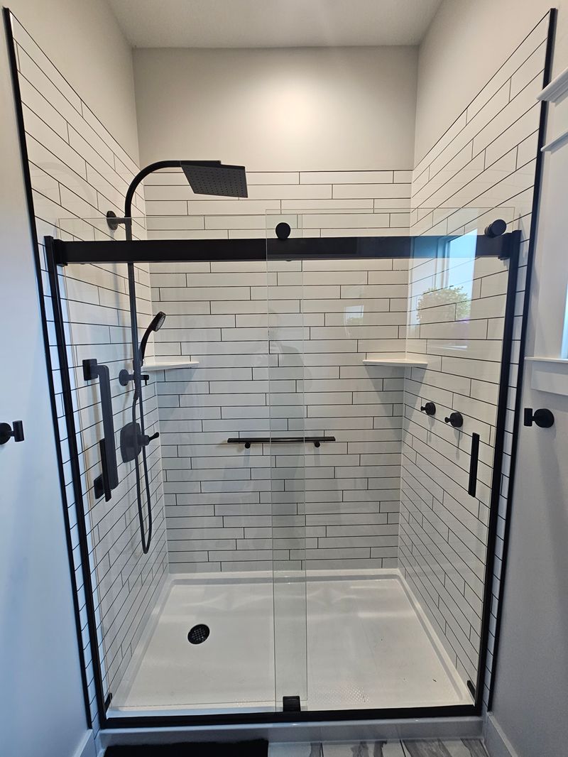 Tile Look shower style with white subway-tile-look walls and black fixtures